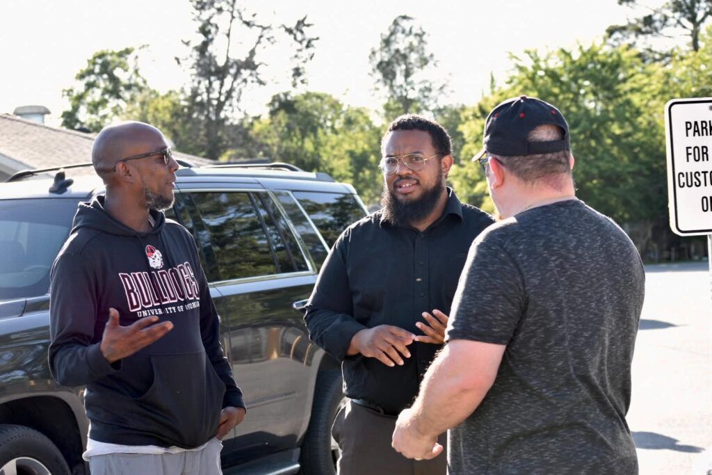 Micah King talking with local residents about community priorities and constituent accountability in District 157