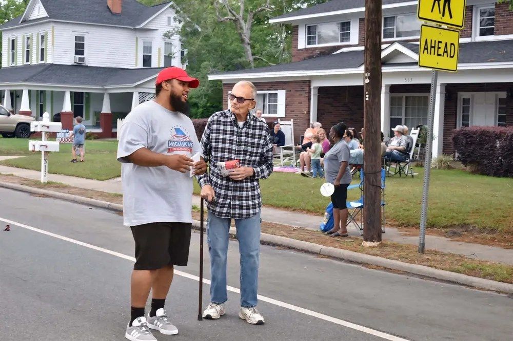 Micah King connecting with voters along the parade route